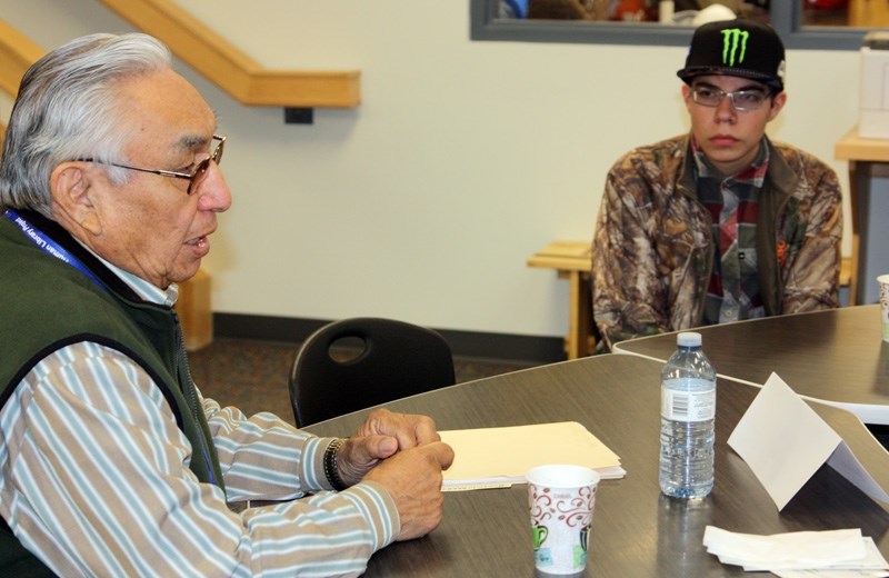 First Nations elder Sykes Powderface discusses with Oilfields High School Grade 10 student Eli Lange on March 3` his experiences of growing up in the Morley area. Powderface