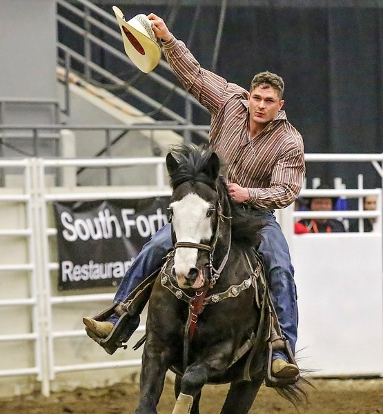 Millarville&#8217; s Taylor Weinberger salutes the crowd after taking home the steer wrestling title at the Canadian Intercollegiate Rodeo Association Finals at the Agrium in 