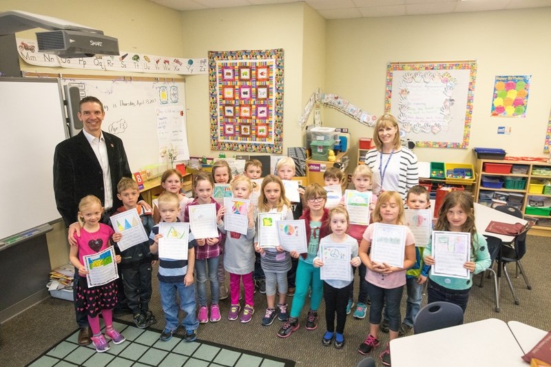 MD of Foothills Division 3 Councillor Jason Parker with Grade 1 students at Millarville School on April 13.