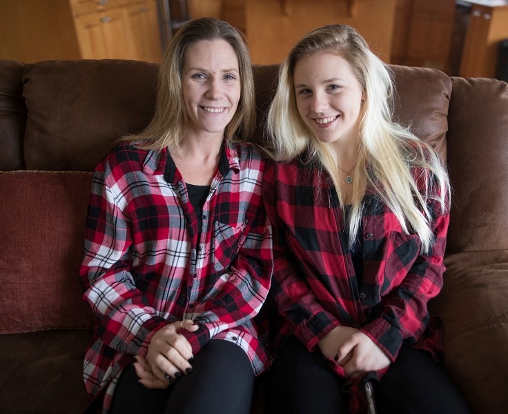 Andrea Lafont with her mom, Nicole in their home on April 21. Andrea was in the back seat of an SUV with her three-year-old cousin when the car was stolen in Calgary.
