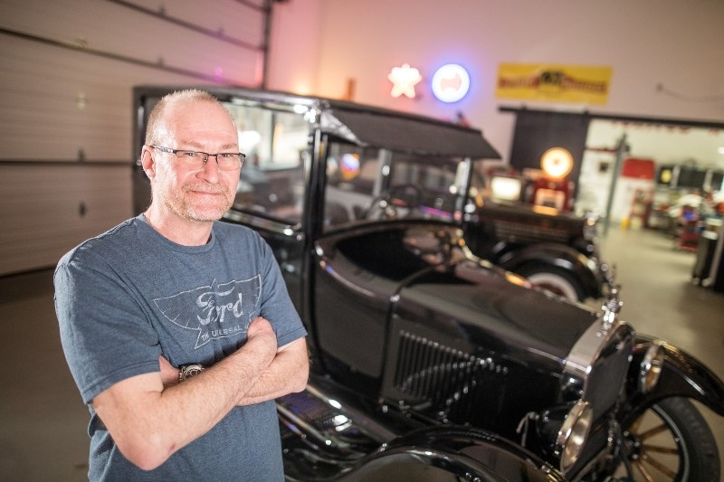 Chris Carroll stands before his 1927 Model T, which he had spent seven years restoring.