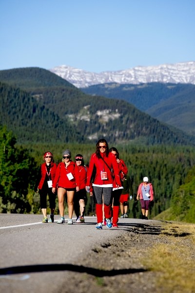 Marchers walk down a Foothills highway during the 2016 Kidney March. The Kidney Foundation has raised more than $5 million to-date with its annual 100-kilometre walk.