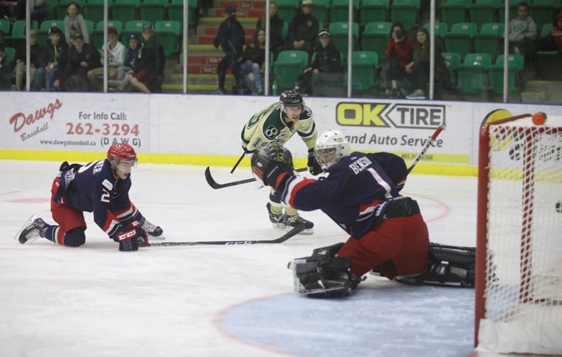 Kaleb Ergang picks the far corner on Brooks Bandits goalie Mitch Benson during Okotoks&#8217; 4-2 win on Sept. 15 at Pason Centennial Arena.