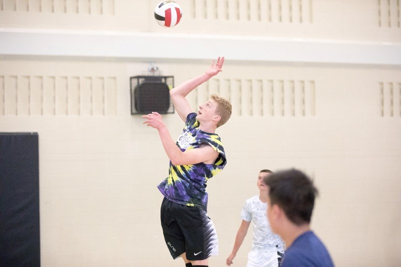 Holy Trinity Academy Knight Ryan Peters practices a serve during a practice on Sept. 13. The Knights are at the Drillers tournament in Black Diamond Sept. 22-23.