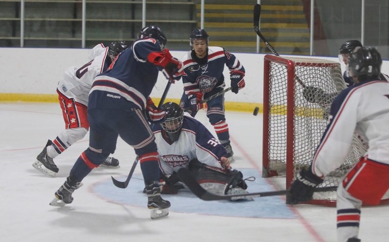 Cochrane Generals goalie Benjamin Daumier stretches out to make a save without his blocker on Okotoks Bison Jason Horn, Sept. 22 at Murray Arena. Okotoks won the game by a
