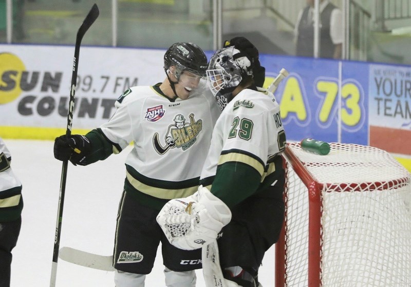 Okotoks Oiler Ben Sanderson celebrates with Ben Howard after the goaltender recorded his first career shutout in a 7-0 win over the Canmore Eagles on Sept. 23.