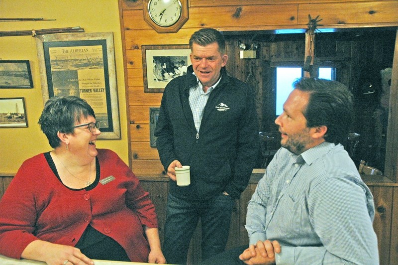 Brian Jean, United Conservative Party leadership candidate, speaks with Foothills School Division Ward 1 candidate Jeannine Tucker and Jamie Wilkie during a campaign stop at