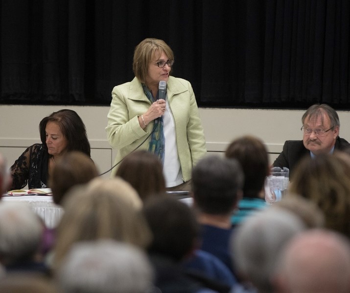 Okotoks council hopeful Karen Neal addresses a standing-room-only crowd at the Okotoks and District Chamber of Commerce candidate forum on Oct. 3.