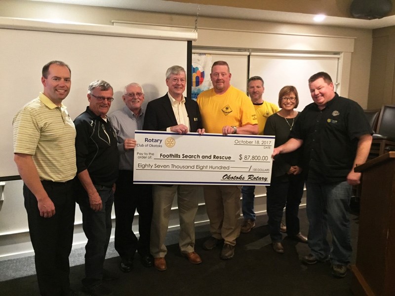 Okotoks Rotary Club members hand off a $87,800 donation to Foothills Search and Rescue on Oct. 18 to go towards a new command vehicle for the organization. From the left: