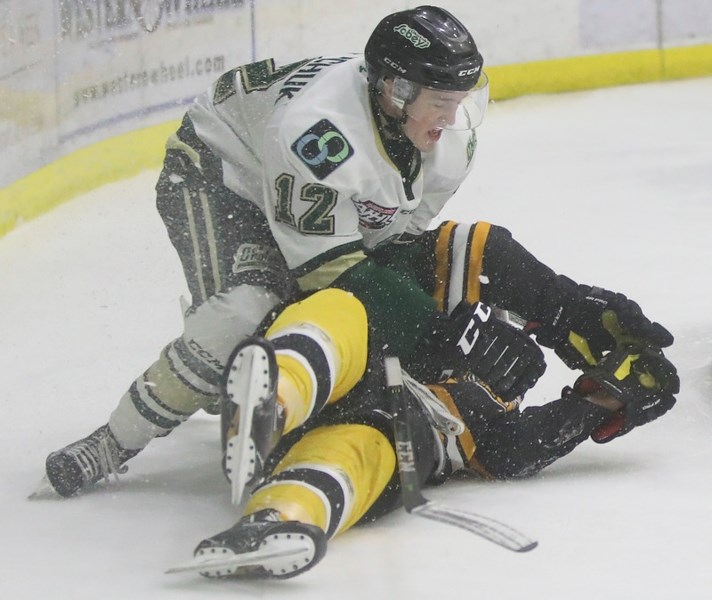 Okotoks Oilers forward Zane Kindrachuk drags an Olds Grizzlys defenceman down during the team&#8217;s 5-1 win, Oct. 20 at Pason Centennial Arena.