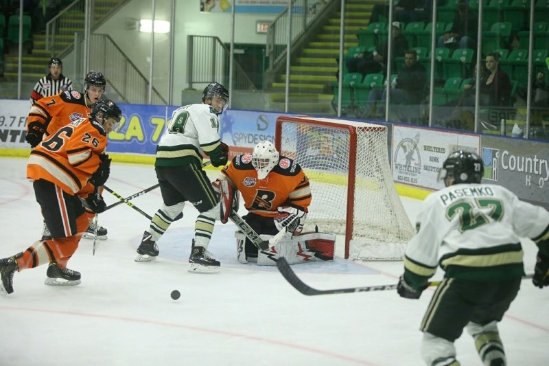 Okotoks Oilers forwards Carter Huber and Mark Pasemko go to the net in search of a rebound during the team&#8217;s 4-2 victory over the Lloydminster Bobcats on Oct. 28 at