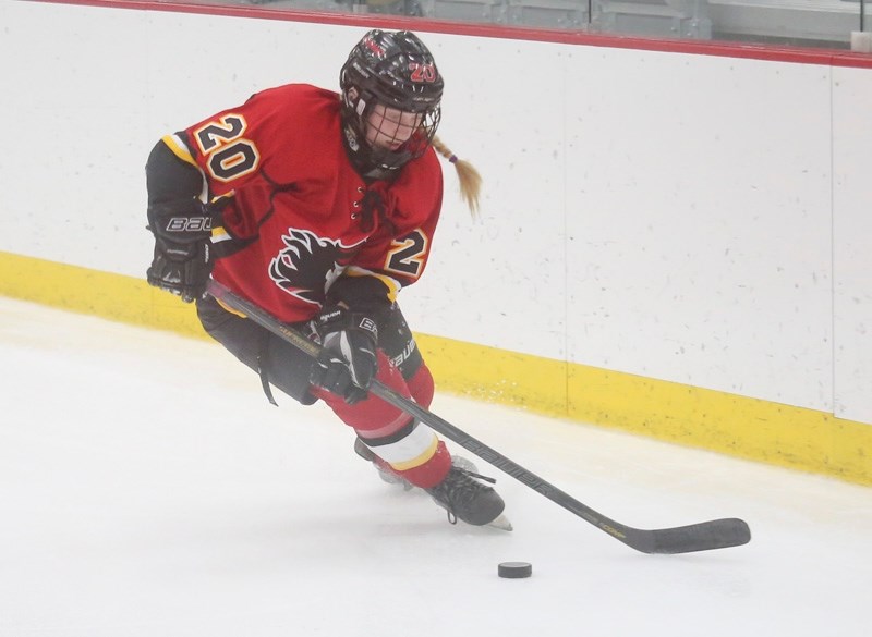 Okotokian Kennedy Brown of the CWHL&#8217; s Calgary Inferno collects the puck during league play versus the Kunlun Red Star on OCt. 29 at WinSport.