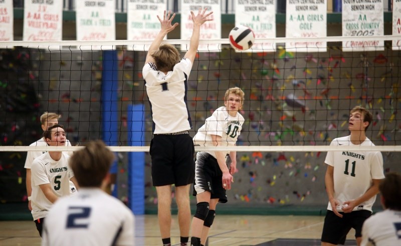 Holy Trinity Academy Knight Ryan Peters watches his spike against the Strathcona-Tweedsmuir Spartans in the Foothills Athletic Council semifinal Senior boys volleyball match