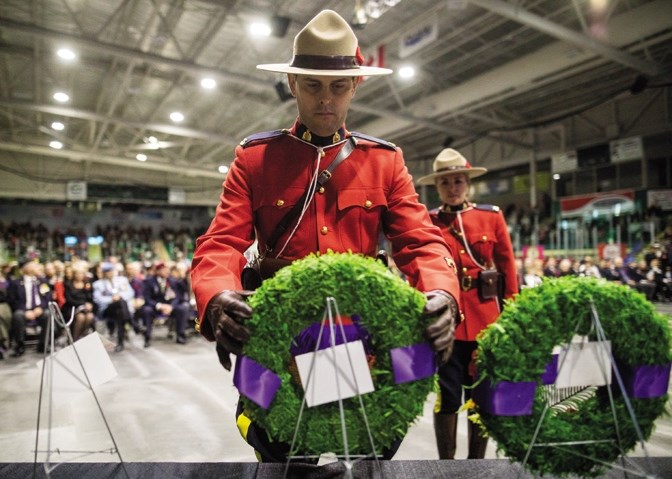 Okotoks RCMP Constables Rob Rogers and Emilie Potvin lay a wreath during the Remembrance Day Ceremony at Pason Centennial Arena in 2016. This year&#8217;s service will begin