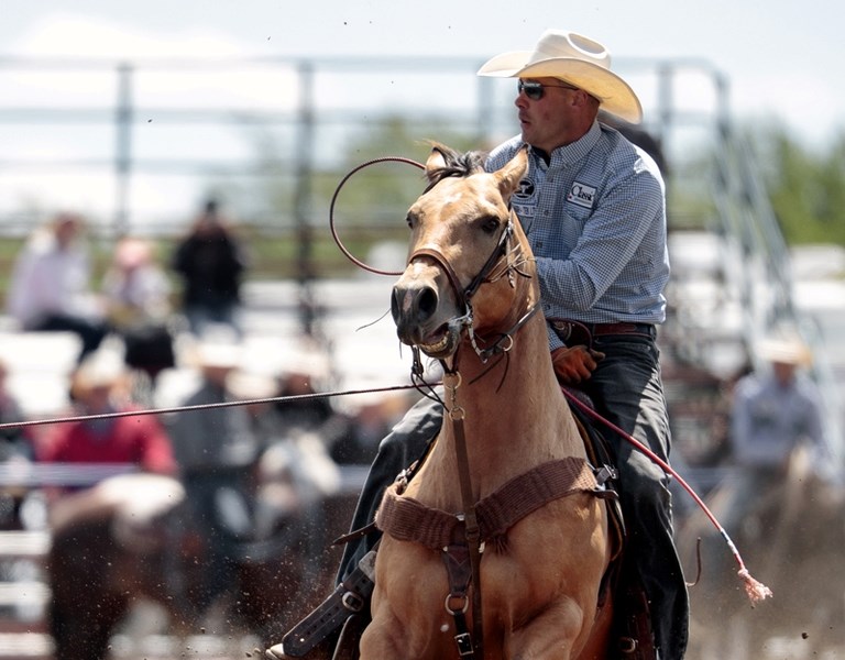 Clint Buhler, here at the Wainwright Stampede, will compete at his seventh Canadian Finals Rodeo in team roping in Edmonton, Nov. 8-12.