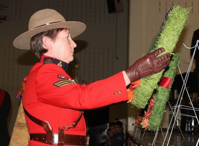 Former Turner Valley RCMP Sgt. Paulina Larrey-King lays a wreath during the Remembrance Day service last year. This year&#8217;s ceremony takes place Nov. 11 at Oilfields