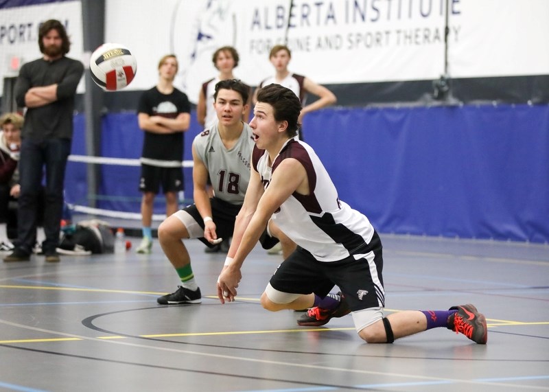 Foothills Falcon Quinn Tocheniuk prepares to bump a pass while libero Noah Matsubara (18) looks on in the team&#8217; s 3-1 victory over the Holy Trinity Academy Knights Nov. 
