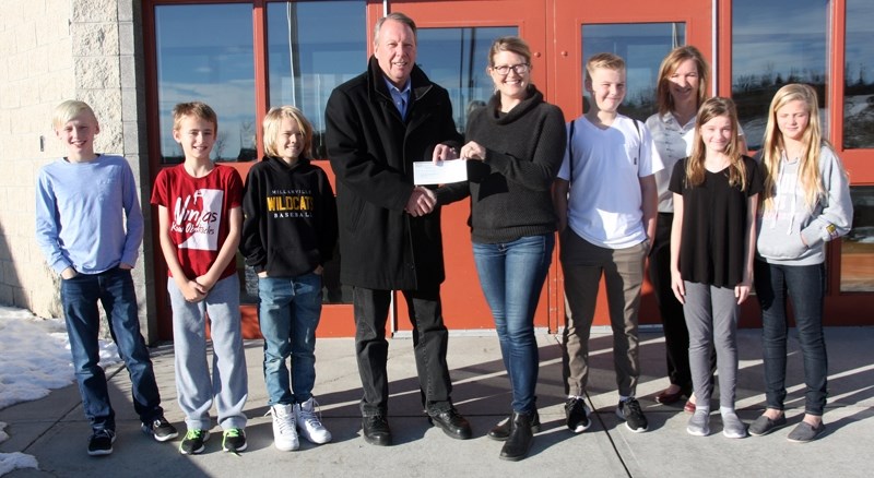 Livingstone Macleod MLA Pat Stier presents a $25,000 cheque to Red Deer Lake school council vice-president Natasha Hubbard for the purchase of audio visual equipment for the