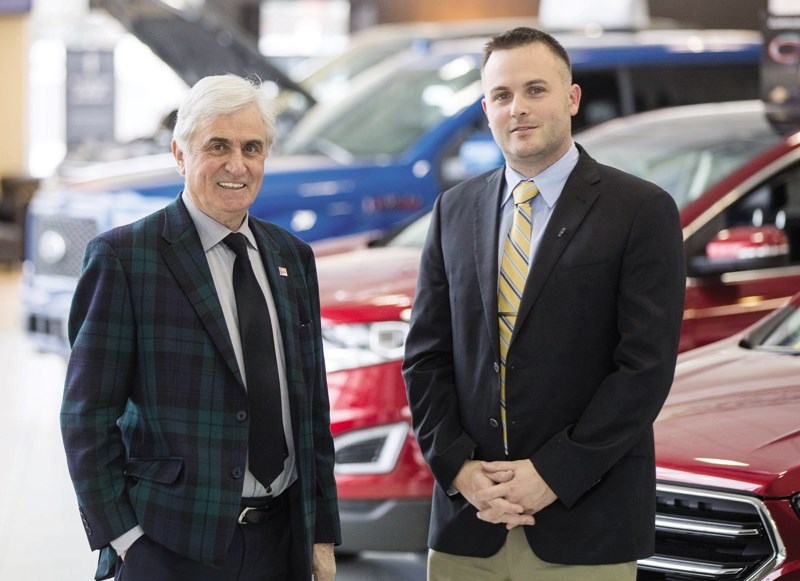 Okotoks Ford owner Gerry Wood and his son Rory, the dealership&#8217; s general manager, in the showroom on Nov. 16. Wood, an Okotoks-area MD resident, was recently inducted