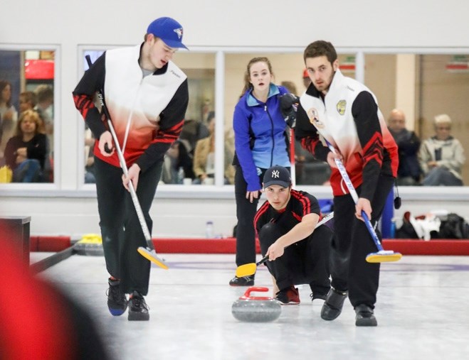 Team Libbus lead Nicholas Warkman watches his shot as sweepers Cailen Knopp and Pacen Anderson await instruction at the Okotoks U15/U18 bonspiel on Nov. 18.