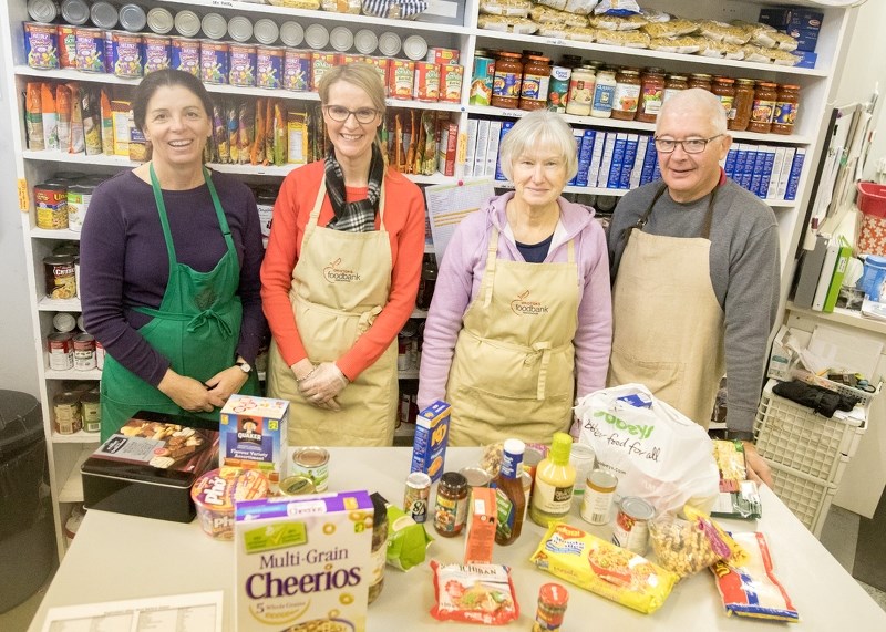 Carol Nerland, Lisa Hagell, Diana Martin, and Brian Martin volunteer at the Okotoks Food Bank Association on Dec. 1.