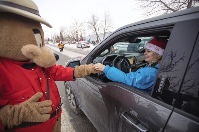 The RCMP Safety Bear takes a donation from a driver at the Charity Checkstop on Milligan Dr. in 2016. This year&#8217;s event takes place from 2 p.m. to 4 p.m. Dec. 14.