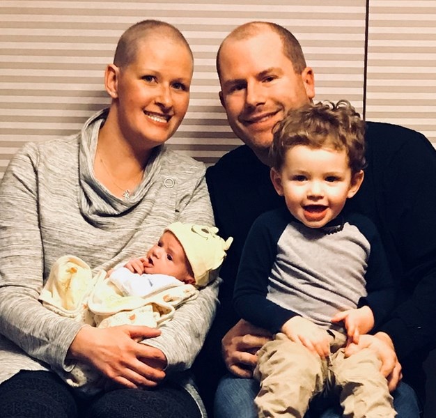 Nicole and Ryan Corbett with one-month-old Myles and two-year-old Luca. Nicole was diagnosed with breast cancer days before she learned she was pregnant with Myles.