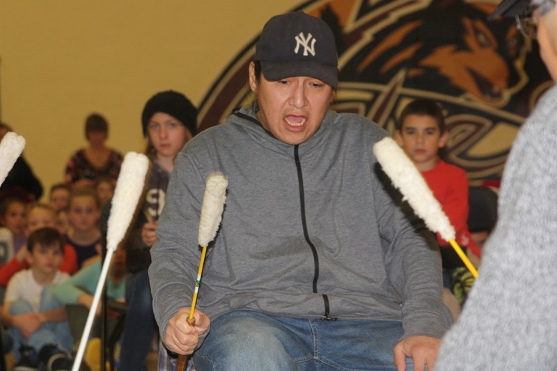 Travis Jimmyjohn, of Eden Valley&#8217; s Spotted Rock Drumming Group, keeps the beat while playing a traditional First Nation&#8217; s song with Grade 4 students at a drum