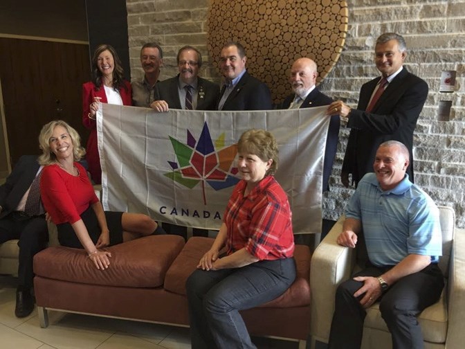 Mayor Bill Robertson poses with the Canada 150 flag along with the Calgary Regional Partnership Board of Directors in May 2017.