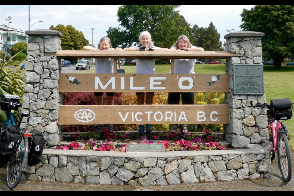 Nynka Greer, left, Jane Sorensen and Kathy Manners are shown in Victoria, B.C., at the zero-km mark of their cross-Canada cycling trip. Supplied photo