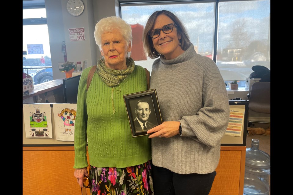 Marci Csumrik, right, is pictured with her mother, Susan, and a photo of her deceased father for whom a local youth dental fund is named. 