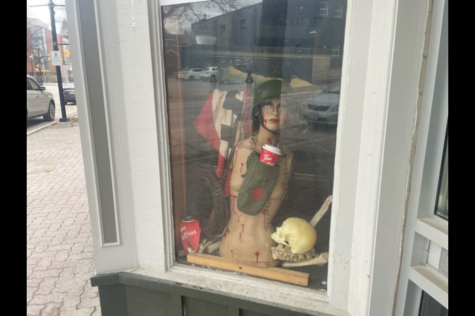The display at Bowen Co. Antiques, located at 65 Mississage St. W., includes a bloodied, nude mannequin and a Nazi flag.