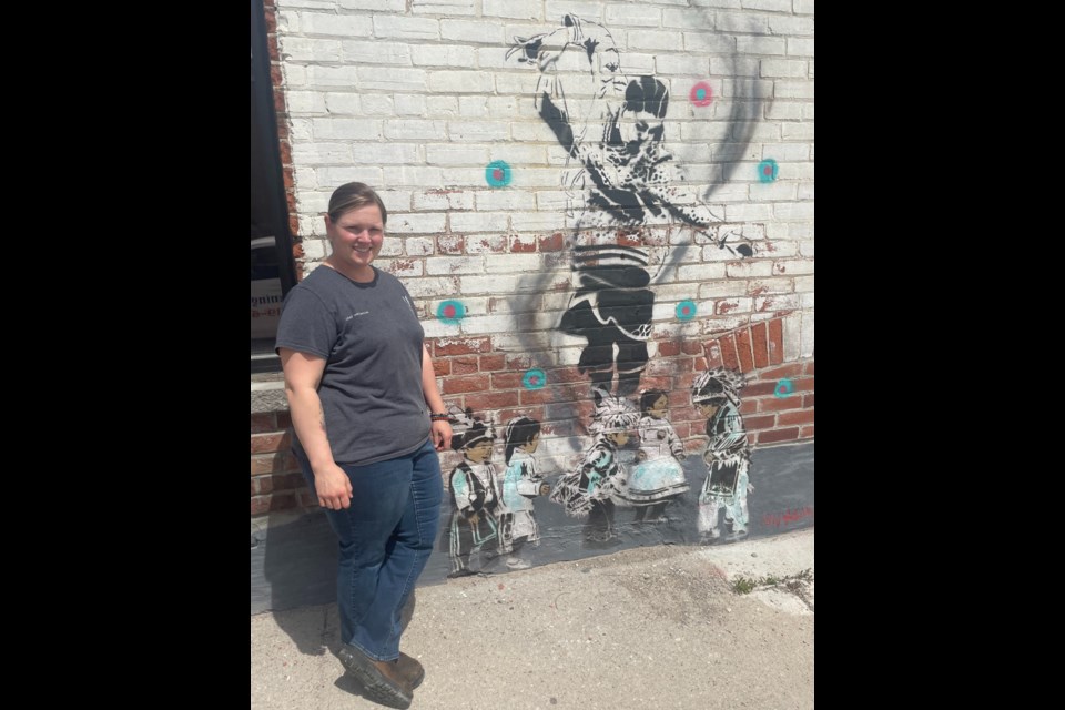 Melanie Robinson, co-owner of Eclectic Café, worked with the city and Indigenous arts collective Windigo Army to have its artwork displayed outside her business. The piece is titled Dance Like Your Ancestors are Watching.