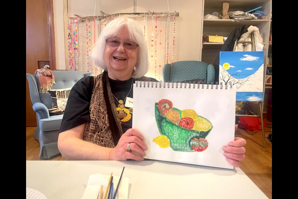 HeARTS participant Yvette Steel is pictured with a piece of artwork she made during the program. 