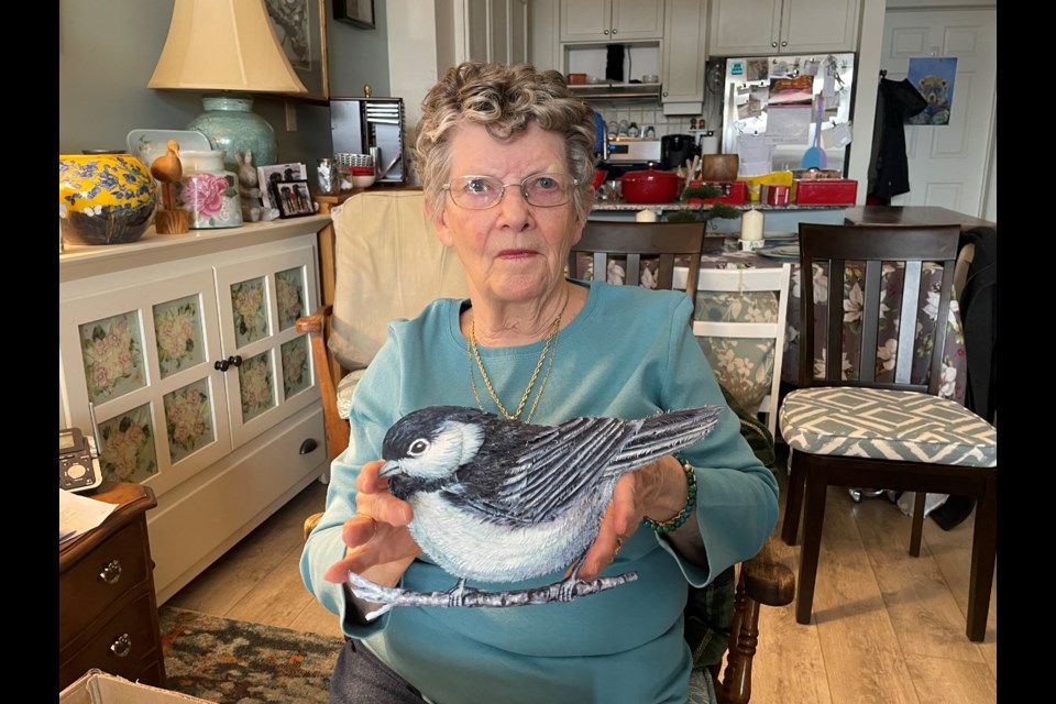 Peggy Little, 83, is pictured here with an in-progress decoupage chickadee. During a hospital stay several years ago, she lost a number of her pieces of art, and she is hoping the public can help her find them. 