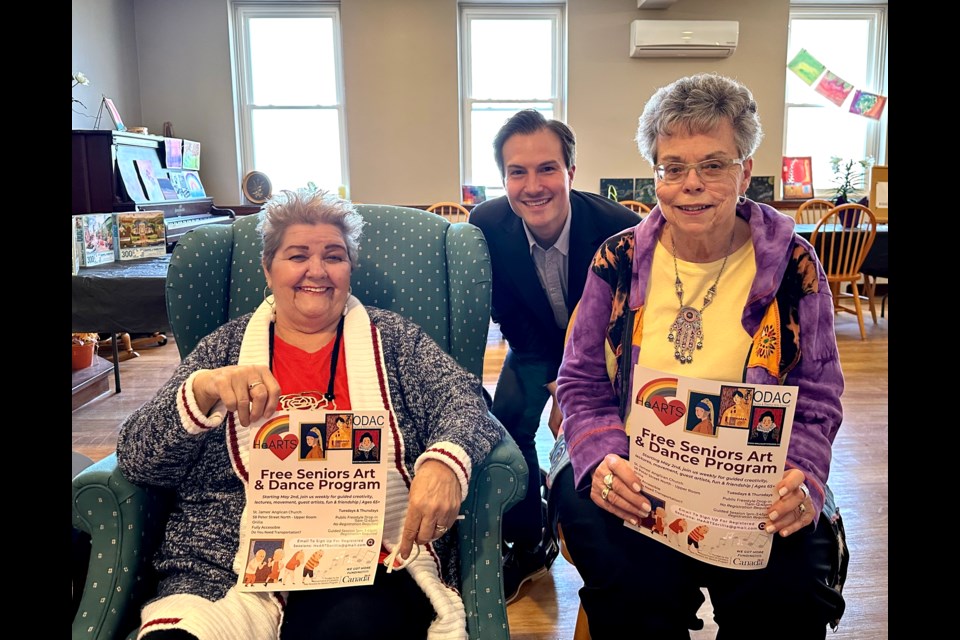 Pictured with Simcoe North MP Adam Chambers, Donna Howlett, left, and Jane Lynch are two program participants eagerly awaiting its return. Thanks to a federal grant, the HeARTS program will run for an additional six months.