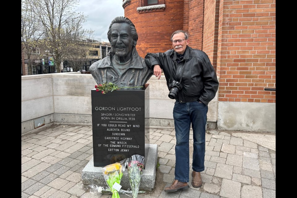 Orillia resident Al Byrnell, a lifelong fan of Gordon Lightfoot, is shown with the bust of the late musician in front of the Orillia Opera House.