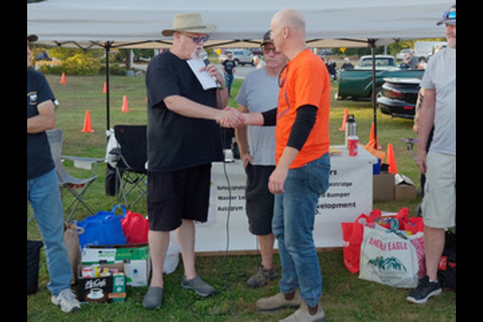 The Back Alley Cruisers donated dozens of bags of non-perishable food items and over $2,300 to The Sharing Place during its final classic car meet-up of the year.