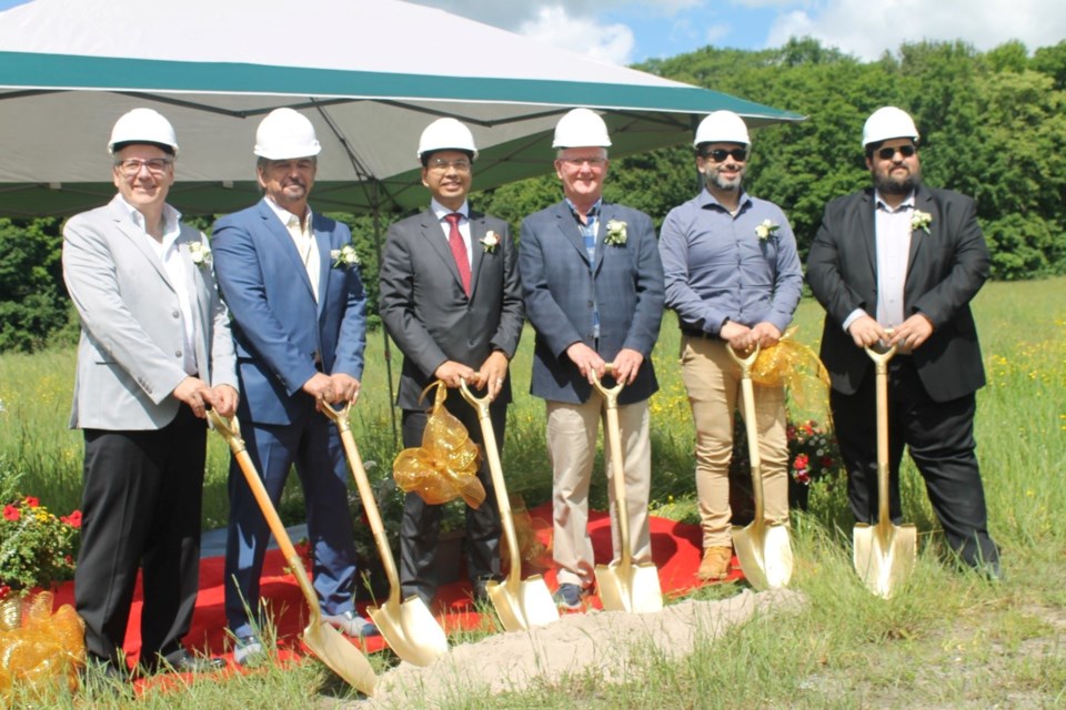 The team from Evertrust Development Group (founder and president Dr. Ted Zhou, third from left) and their construction company TQC Construction Group, join Steve Clement, District Councillor for Bracebridge and Deputy Chair with the District of Muskoka (4th from left) at the site.