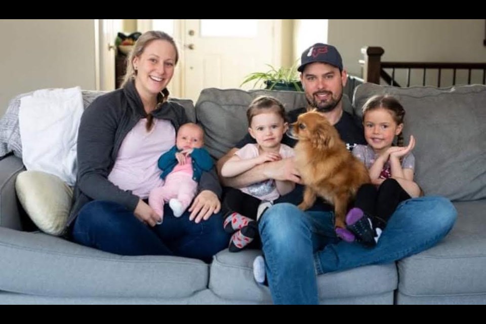 Kristin Vanden Heuvel and Jeff Wilson are pictured with their three daughters and beloved pet, Grizzly, who passed away on Labour Day. 
