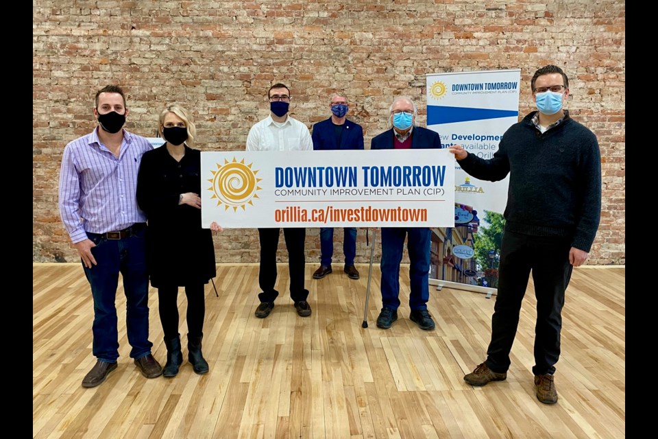 Downtown Tomorrow Community Improvement Plan grants were handed out Friday at Creative Nomad Studios. From left are Jesse Henneveld, Emily Baker, Coun. Mason Ainsworth, Mayor Steve Clarke, Coun. Ted Emond and Jeff Pitcher. Nathan Taylor/OrilliaMatters