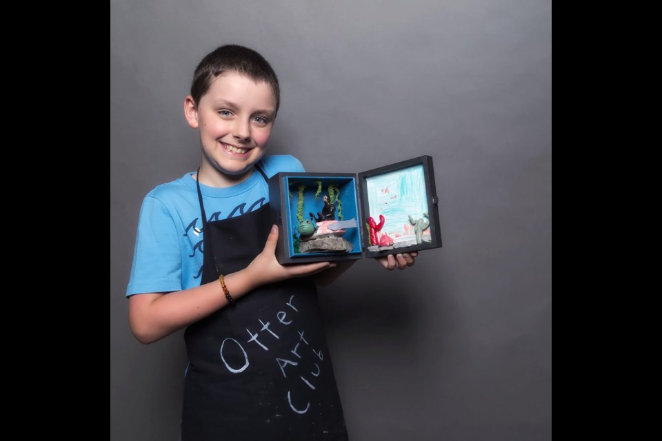 Toby, 9, shows off the diorama he made at the Otter Art Club. Supplied photo