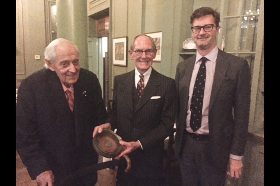 Thomas Symons, left, presents the Stephen Leacock Medal for Humour won by his father, Harry Symons, in 1947 to University Club of Toronto president D. Ross Peebles, centre, and Neil Guthrie, a member of the club's art committee. It was the first Leacock Medal that was awarded. Supplied photo