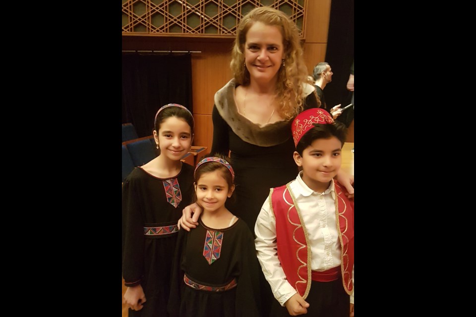 Governor-General Julie Payette is shown with three members of the Nai Children's Choir, which will perform in Orillia, with the Orillia Vocal Ensemble, Feb.24.