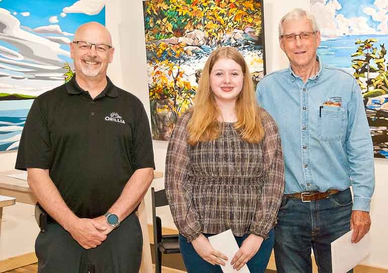 Katelyn Wilson, centre, won first place in Sustainable Orillia's art contest. She is shown with Orillia City Councillor David Campbell, left, and Fred Larsen of Sustainable Orillia.