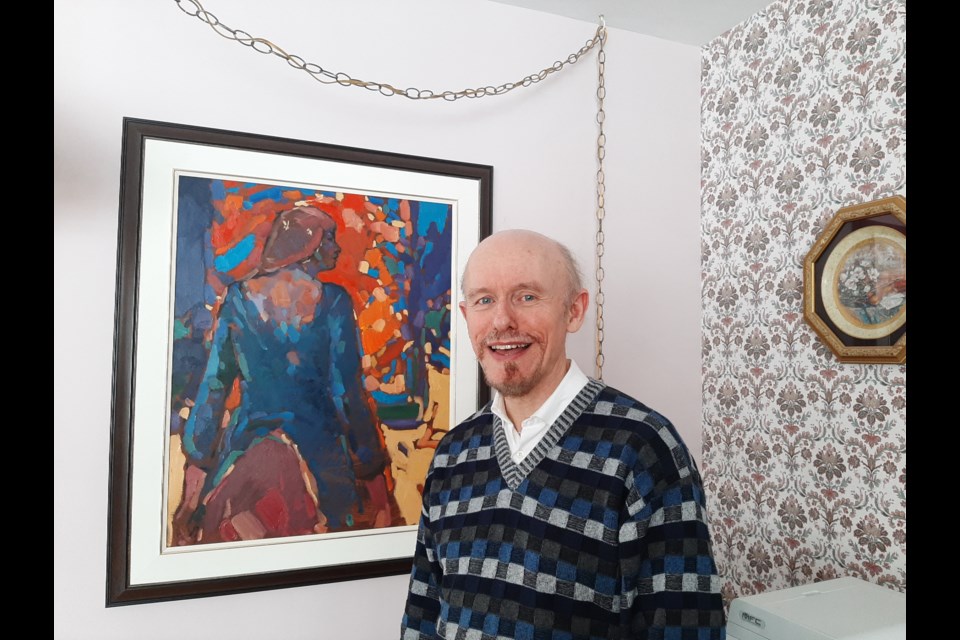 Blair Bailey is pictured in his home in front of a painting by Travis Shilling. “We are so lucky in the wealth of artistic talent we have in our area,” he says. Anna Proctor/OrilliaMatters