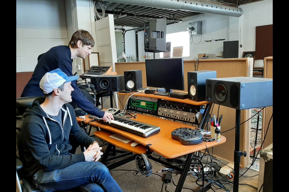 Taylor Knox and Nixon Boyd are shown trying out some of the recording equipment in their new sound studio, Simcoe Mechanical.