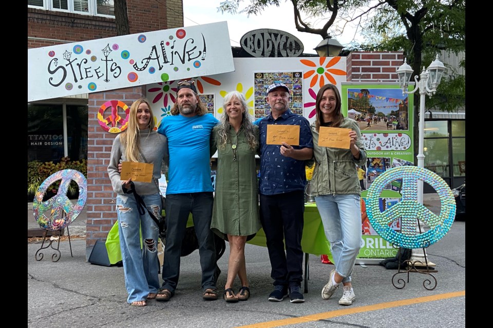 The winners of the popular Streets Alive event were announced at a ceremony in downtown Orillia Friday night. Winners, from left: Carley McCutcheon and Frank Ripley (third), event founder Leslie Fournier, David Shaw (first place) and Samantha Vessios (second place).