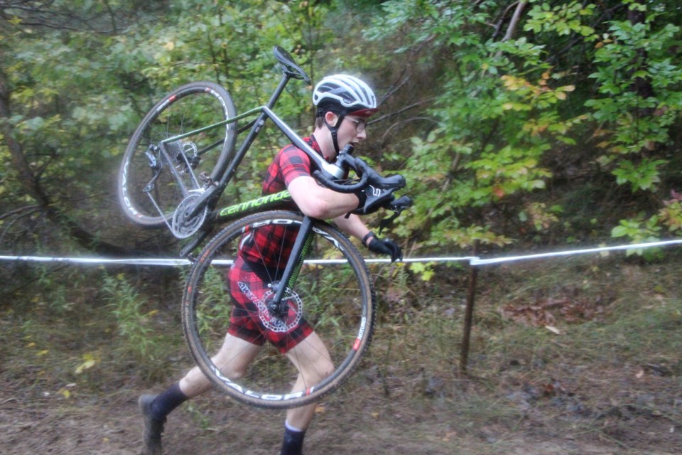 Running with your bike on your shoulder is all part of the strategy in winning a cyclocross race. Here, Brody Sanderson gets through a tough section in no time, even while carrying his bike.