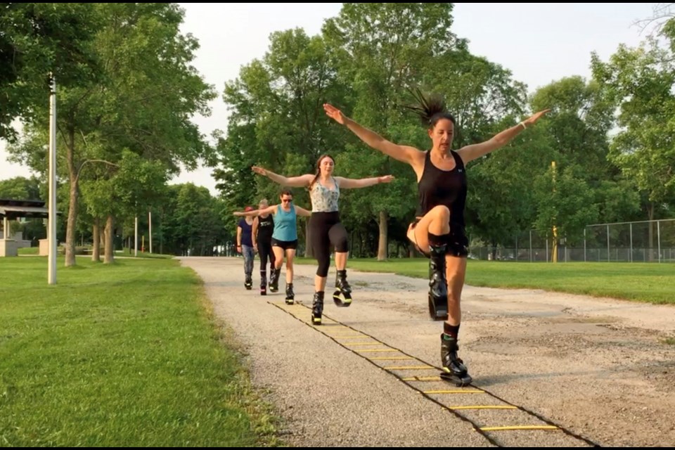 Kangoo Boot Camp instructor, Melissa McKee, leads participants through an agility ladder, just one of the components of a new fitness program featuring rebounding boots.
